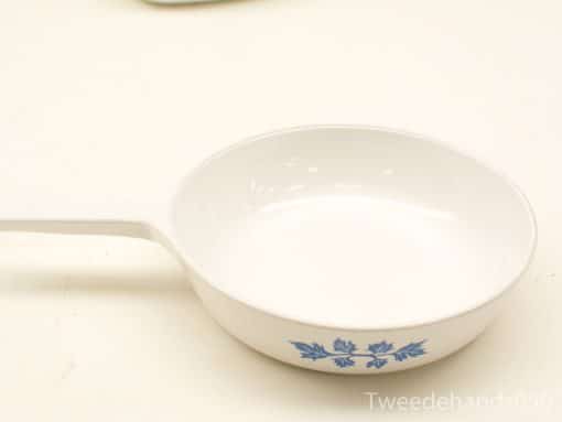 Elegant white serving dish with blue floral design, perfect for cooking and serving.