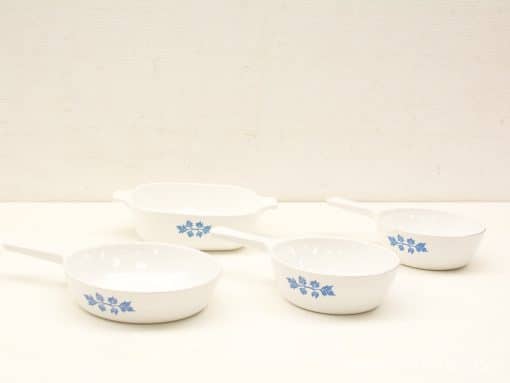 Elegant vintage white ceramic dishes with blue floral pattern for stylish serving.