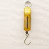 Vintage yellow pocket balance scale for precise weighing of small items.