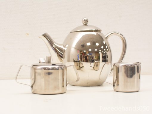 Elegant stainless steel tea set with teapot, sugar bowl, and creamer for stylish gatherings.