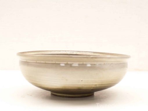 Elegant ceramic bowl with a handmade design, perfect for serving or as a decorative accent.