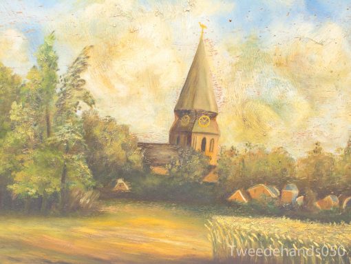 Picturesque village with historic church, lush trees, and golden harvest field under a serene sky.