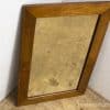 Vintage wooden mirror with patina, perfect for adding charm and nostalgia to any space.