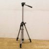 Lightweight vintage aluminum tripod with adjustable height and pan-tilt head for versatile photography.