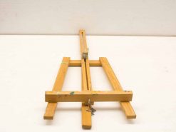 Vintage wooden easel with colorful paint splatters, ideal for artists and creative projects.