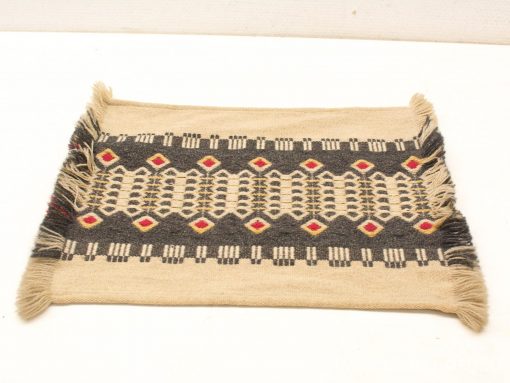 Handwoven vintage rug with diamond patterns in beige, gray, and red accents. Perfect decor piece.