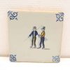 Vintage tile featuring two figures in conversation, vibrant colors and elegant patterns enhance decor.