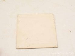 Vintage cream tile with charming imperfections, ideal for decor or as a coaster.
