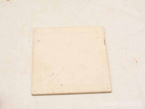 Vintage cream tile with charming imperfections, ideal for decor or as a coaster.