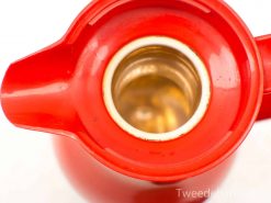 Vibrant red vintage teapot with glossy finish, perfect for functional use and decoration.
