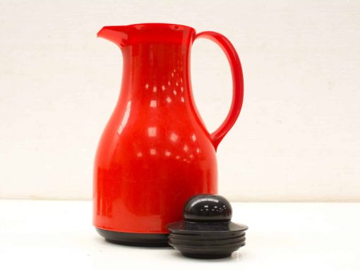Red pitcher with sleek black lid, perfect for stylish decoration or everyday use.