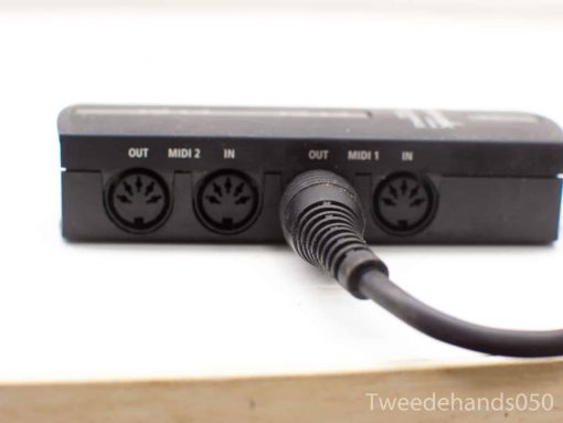 Compact MIDI interface for music production with multiple connection ports for versatile setups.