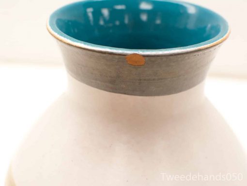 Charming turquoise vintage vase with unique chip and elegant design, perfect for any decor.