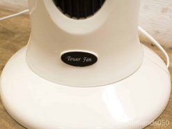 Sleek white tower fan with remote control for efficient cooling in any space.