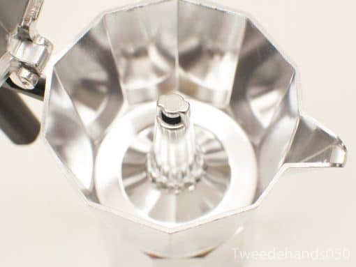 Shiny vintage aluminum moka pot for brewing rich Italian coffee with elegant design.