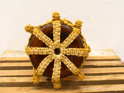 Stylish vintage pot with woven lid, showcasing natural textures and artisan craftsmanship.
