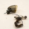 Rustic vintage bicycle light with dynamo, showcasing classic design and timeworn charm.