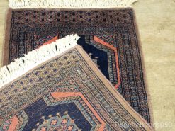 Stunning vintage Persian rug with intricate geometric patterns in rich navy and burgundy hues.