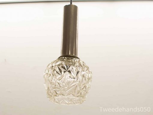 Vintage pendant lamp with geometric glass shade, blending modern and classic design elements.