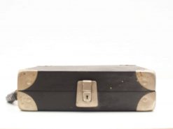 Classic black vintage suitcase with metal latch and leather handle, perfect for stylish travel.