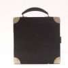 Elegant vintage black case with leather handle and metallic corners, perfect for travel or storage.