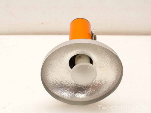 Stylish handheld spotlight with glossy reflector and bright orange casing, ideal for photography and outdoor use.