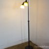 Sleek modern floor lamp with amber and white glass shades for stylish ambient lighting.