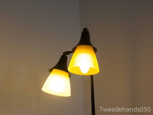 Stylish vintage floor lamp with dual shades, providing a warm glow for modern interiors.