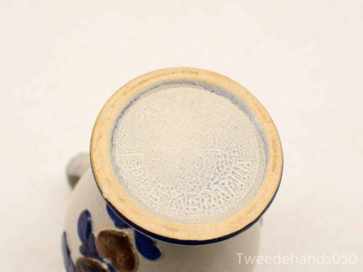 Vintage ceramic mug showcasing handcrafted details and unique makers mark, perfect for collectors.