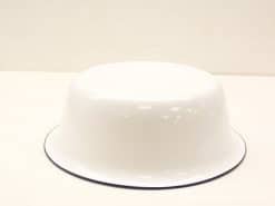 Elegant white enamel bowl with black rim, perfect for serving and decor.