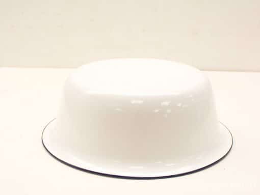 Elegant white enamel bowl with black rim, perfect for serving and decor.