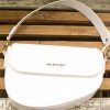 Elegant white Valentino handbag with glossy finish and gold accents for versatile styling.
