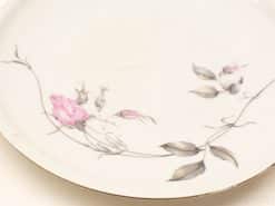 Elegant porcelain plate with floral motifs, featuring a pink rose and luxurious golden rim.