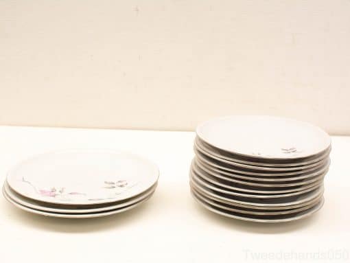 Elegant vintage porcelain plates with floral design, perfect for refined dining occasions.
