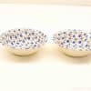 Elegant ceramic bowls with blue floral patterns, perfect for serving snacks and desserts.