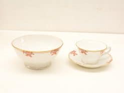 Elegant porcelain tea set with gold accents and intricate pink motifs, perfect for any occasion.