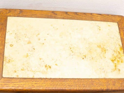 Elegant marble tabletop with rich wooden frame, perfect for rustic and farmhouse decor.