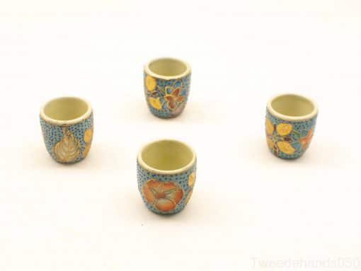 Vibrant vintage ceramic cups with floral designs, perfect for espresso or decorative use.