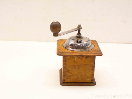 Vintage wooden coffee grinder with metal mechanism, perfect for grinding beans and adding rustic charm.