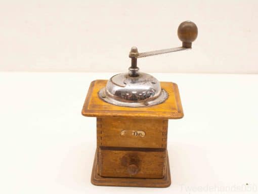 Vintage wooden coffee grinder with metal mechanism, perfect for enthusiasts and collectors.