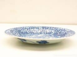 Elegant blue and white porcelain plate with floral patterns, perfect for decor or special occasions.