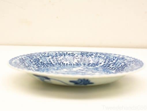 Elegant blue and white porcelain plate with floral patterns, perfect for decor or special occasions.