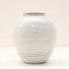 Elegant white ceramic vase with subtle striations, perfect for minimalist decor and flower arrangements.