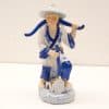 Traditional Chinese porcelain worker figurine, kneeling with shovel, celebrating agricultural heritage and craftsmanship.