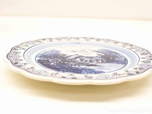 Elegant Delft Blue plate depicting a charming house and serene landscape for home decor.