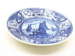 Beautiful blue and white porcelain plate featuring sailing boats and floral designs.