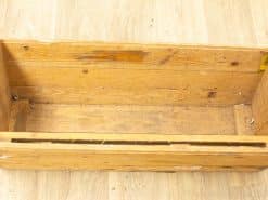 Rustic wooden box with history, perfect for vintage decor and flexible storage options.
