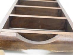 Dark wooden organizing tray with handle, ideal for desks and workshops.