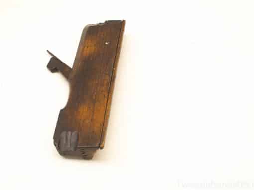 Vintage wooden firearm component featuring intricate grain and functional design, ideal for collectors.