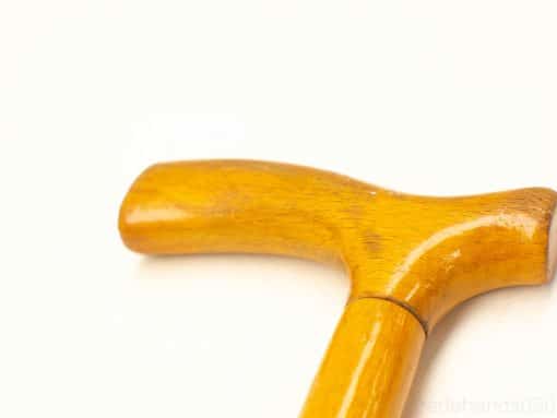 Elegant wooden cane with T-handle, polished finish, ergonomic grip, and aesthetic appeal.